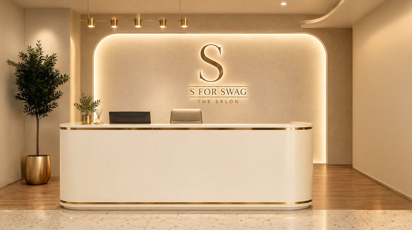 S For Swag salon reception with a cream and gold desk and illuminated salon sign
